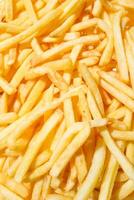 Golden French fries potatoes background. Macro. Photo can be used as a whole background.