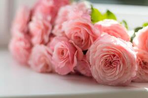Bouquet of pink roses on a white background. Selective focus. photo