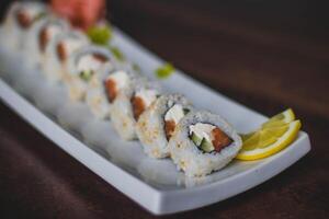 Sushi roll with salmon, avocado, cucumber and cream cheese photo