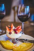 Cottage cheese with strawberries and raspberries served in a glass photo