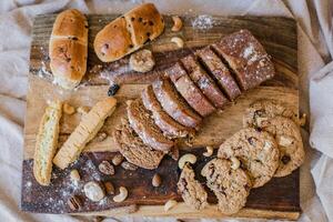 Homemade bread with nuts and raisins on a wooden board photo