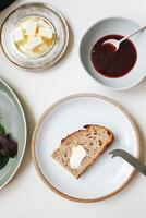 Slices of bread with butter and jam on a white background photo