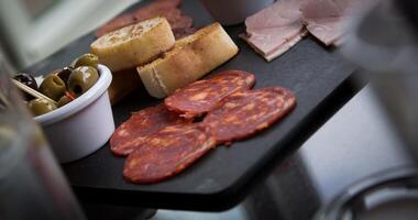 Appetizer with salami, olives, bread and toast photo