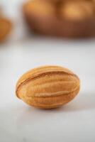 Almond nuts on white background. Selective focus. Shallow depth of field. photo