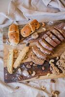 Homemade wholemeal bread with nuts and raisins on wooden board photo