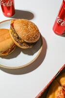 Close up of Coca-Cola and hamburger on white background. photo