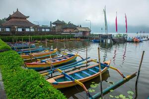 Group of traditional Balinese kayak floating in area of Pura Ulan Danu Bratan temple photo