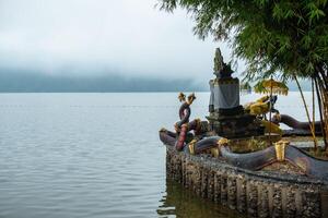 Spiritual shrine in Pura Ulan Danu Bratan temple at the shore of lake Bratan the second largest lake in Bali, Indonesia in the morning. photo