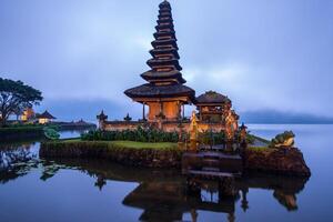 View of Pura Ulan Danu Bratan a famous picturesque landmark and a significant temple on the shores of Lake Bratan in Bali, Indonesia. photo