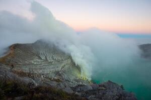 Beautiful scenery view of Kawah Ijen volcano in Java island of Indonesia at dawn. photo