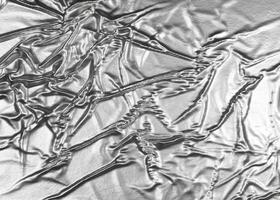 Crumpled white aluminum foil background photo