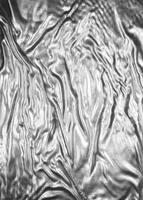 Crumpled white aluminum foil background photo