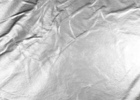 Crumpled white aluminum foil background photo