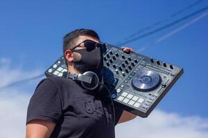 dj with headphones and mixer in the park, the dj at work photo