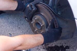 mechanic changing car wheel, car mechanic changing the wheel of a car photo