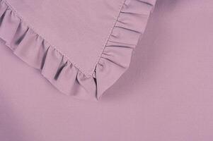 Detail of the collar of a purple blouse, macro photo. Fabric as a background. photo