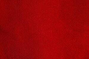 Red suede as a background material for designers. Red velvet background. photo