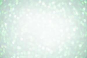 Defocus lights white on light green color. Abstract background with blurred sparkles. photo