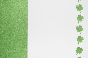 Glitter green and white background with sparkly clover shamrock photo