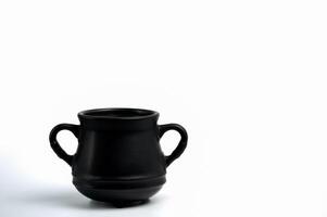Black cauldron pot on white background photo