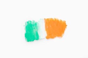 Green white and orange color paint splotches on white background photo