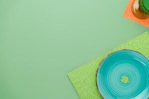 Green place setting for St Patricks dinner with a clover photo