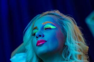 portrait of a woman with painted face, woman with uv makeup in studio, portrait of a woman in carnival mask, the woman is decorated in a ultraviolet powder photo