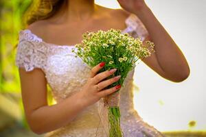 Wedding Bride Holding Bouquet of Flowers photo