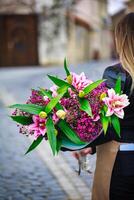 Woman Walking Down Street With Bouquet of Flowers photo