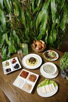 Wooden Table Set With Platters of Delicious Food photo