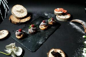 Black Plate With Pastries and Flowers photo