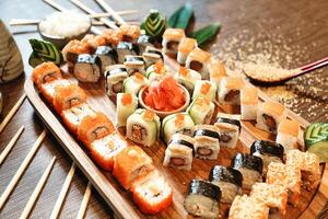 Wooden Tray Filled With Sushi and Chopsticks photo