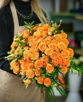 Woman Holding Bouquet of Orange Roses photo