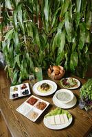 Wooden Table With Plates of Food photo