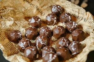 Assorted Chocolates Arranged on Top of a Sheet of Paper photo