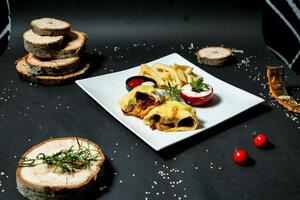 White Plate With Food Next to Bread Slices photo