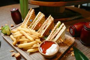 Wooden Tray With Half Sandwich and French Fries photo