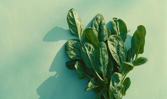 AI generated Spinach leaves on blue background. Top view, copy space photo