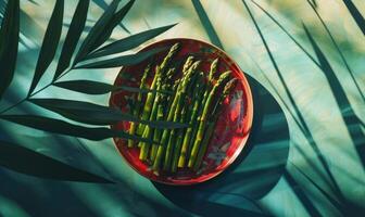 AI generated Green asparagus in a red plate on a blue background. photo