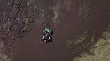 Festival of off-road lovers. SUVs drive the swamp. Cars skid in the mud. Outdoor, adventures and travel. Aerial view video