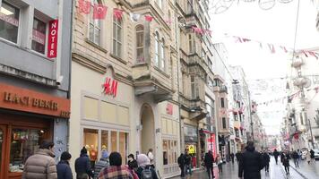 turkey istanbul 17 january 2024.Pedestrians passing by the HM stores window display at taqsim square video