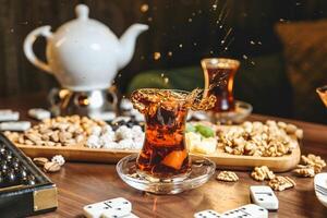 Table With Dice and Glass of Liquid photo