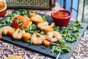 Platter of Grilled Shrimp Skewers on Wooden Table photo