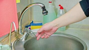 bare caucasian man washing striped dish with liquid soap detergent and blue-yellow sponge video