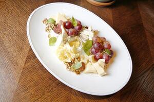 White Plate With Grapes and Cheese photo