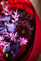 Vibrant Purple and Red Bouquet in Red Wrap photo