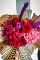 Bouquet of Flowers Resting on Book photo