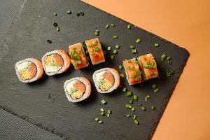 Black Plate With Sushi on Table photo