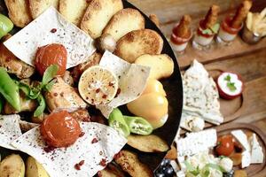 Platter of Appetizers and Snacks on a Wooden Table photo