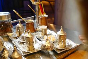 Shiny Metal Tray With Abundant Gold Cups and Saucers photo